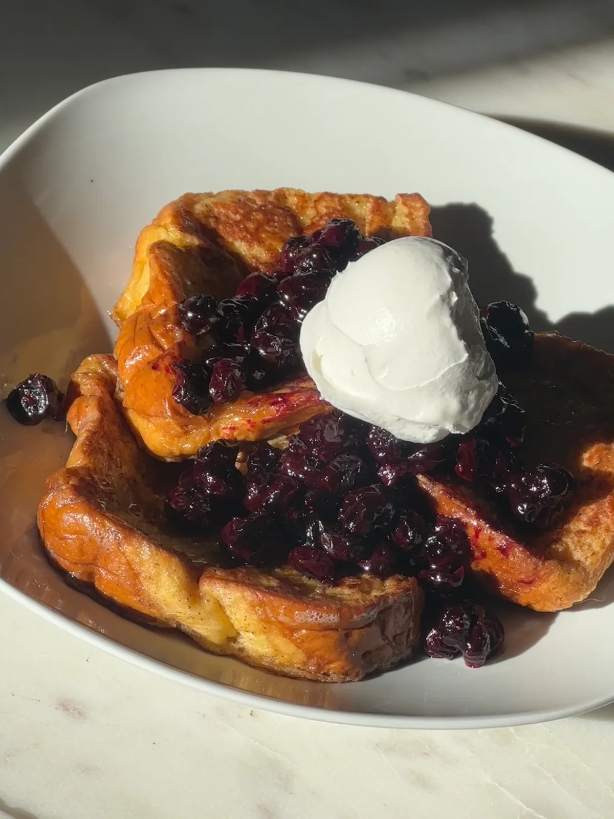 Berry french toast topped with mascarpone cream and fresh berries