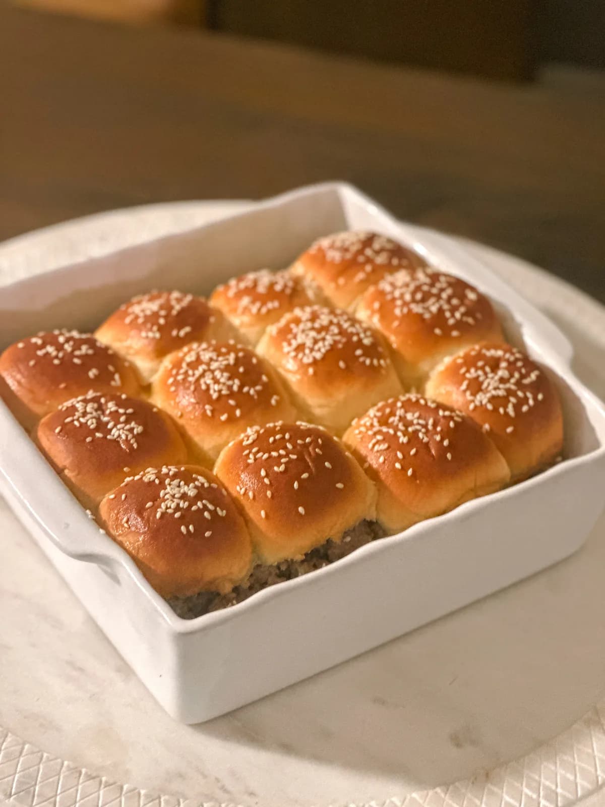 Mini slider burgers stacked on a board ready to serve