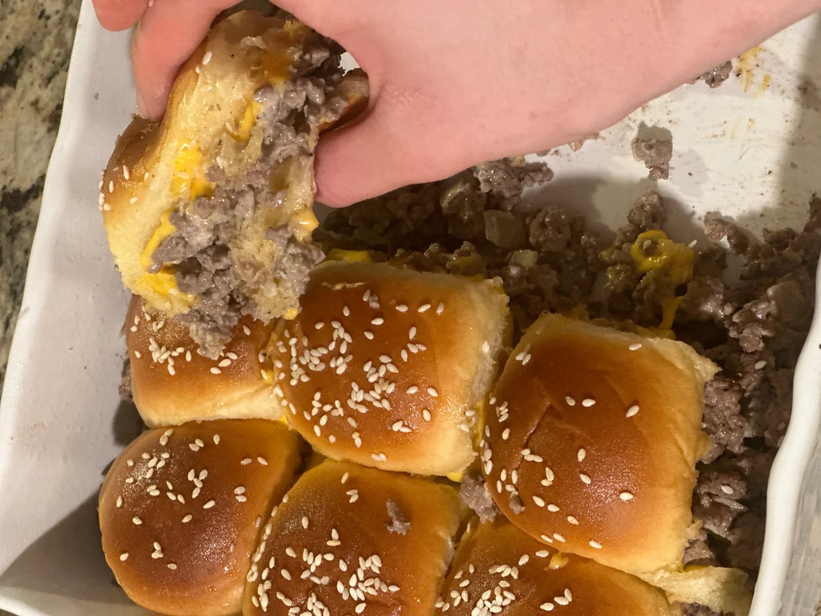 Sliced homemade burger buns showing a soft interior crumb