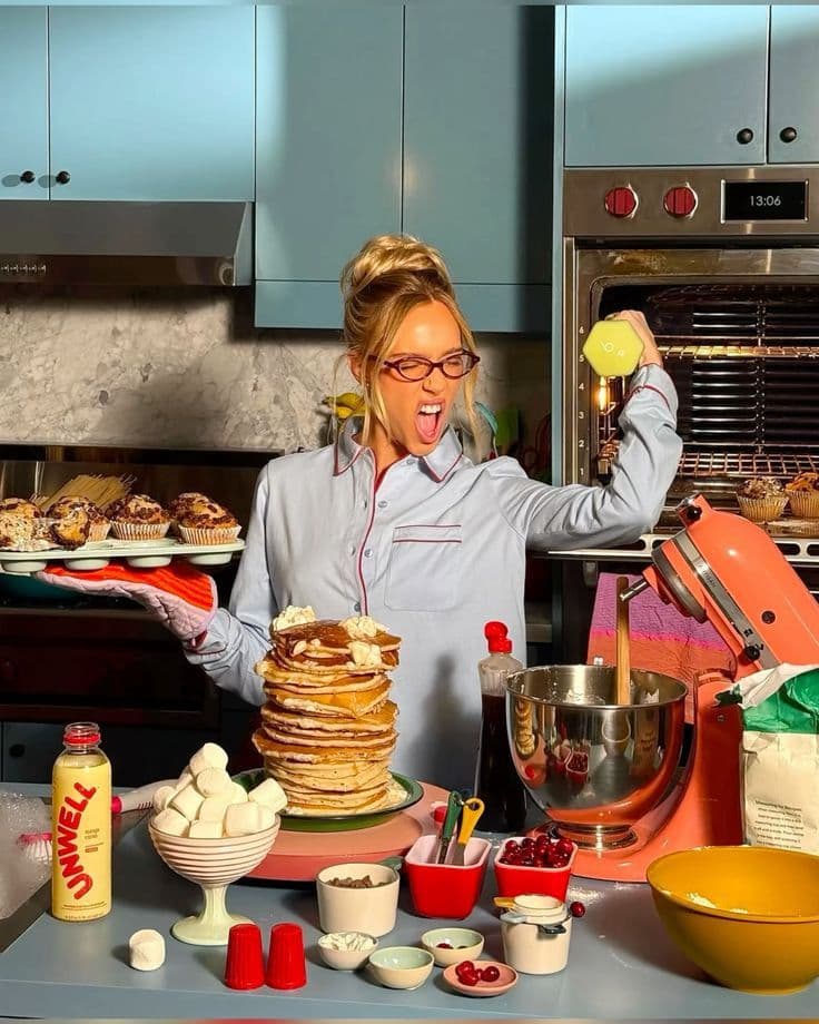 A busy kitchen with pancakes, pastries, and batter in progress