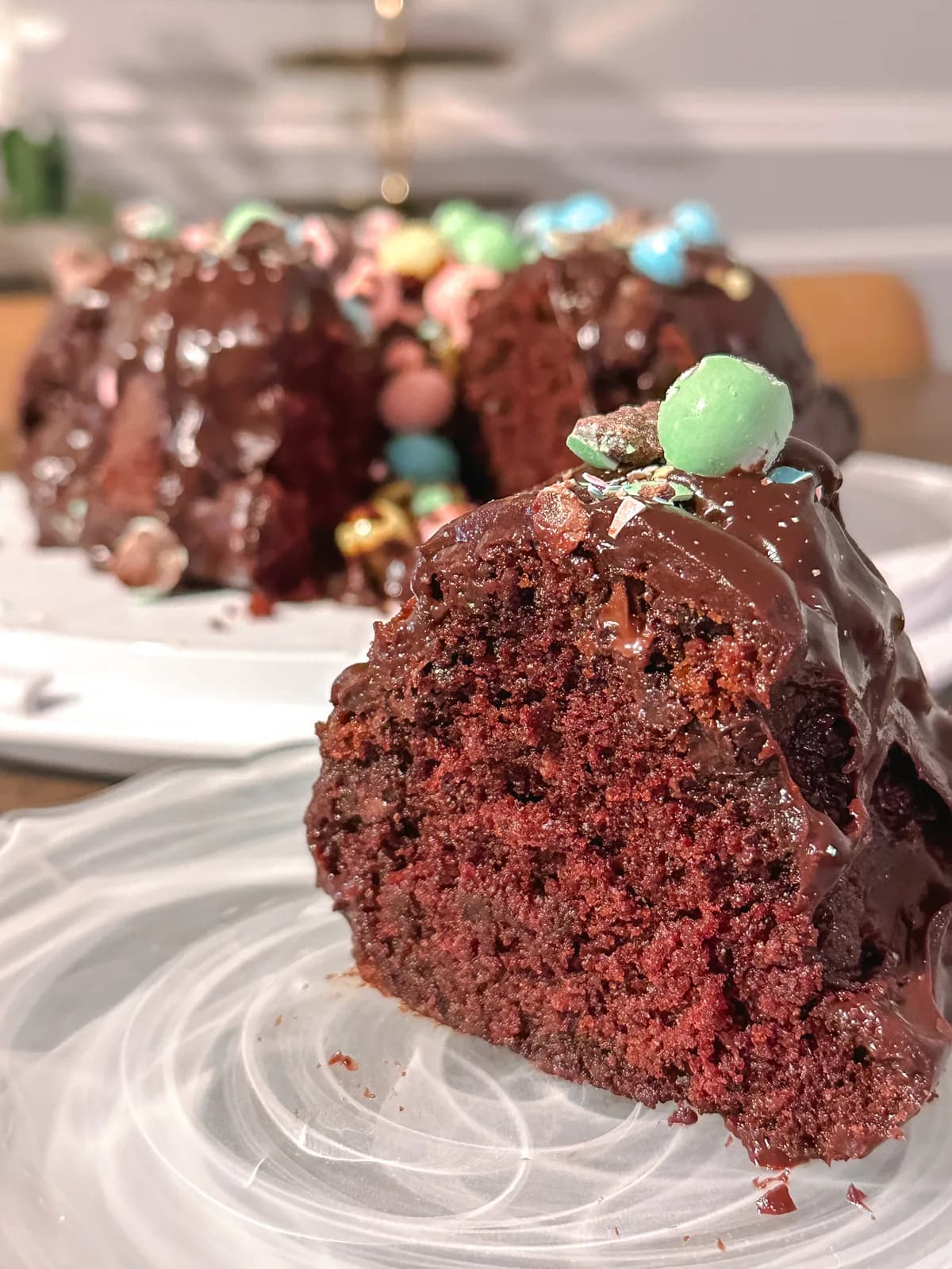 A chocolate bundt cake with glaze, decorated for spring