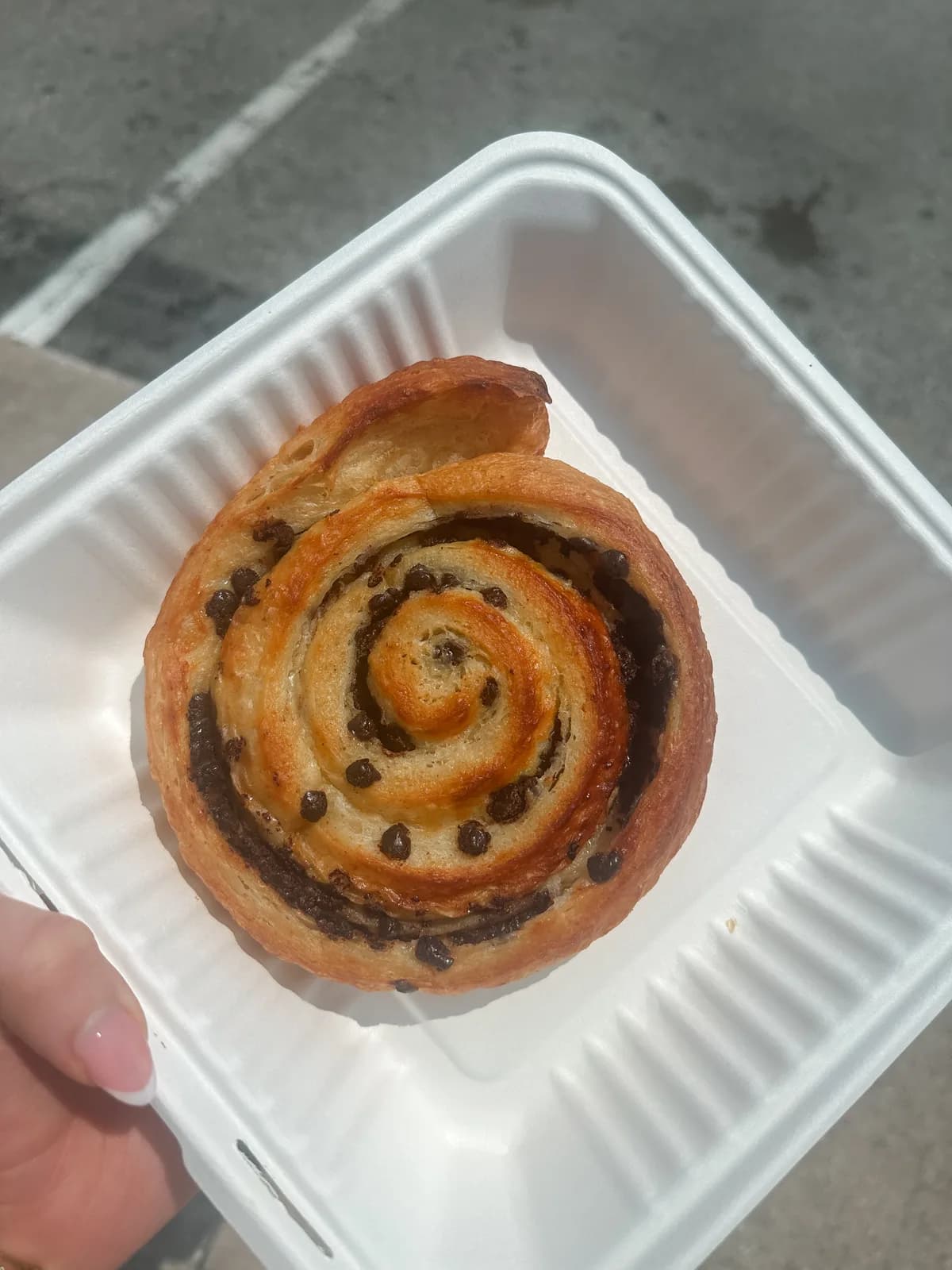 A close-up of a croissant showing its layered swirl pattern