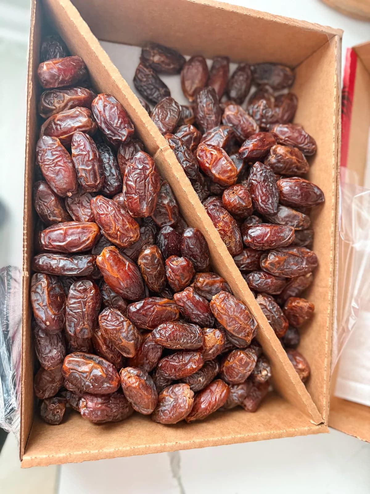 Medjool dates filled with creamy filling and drizzled with honey on a ceramic plate