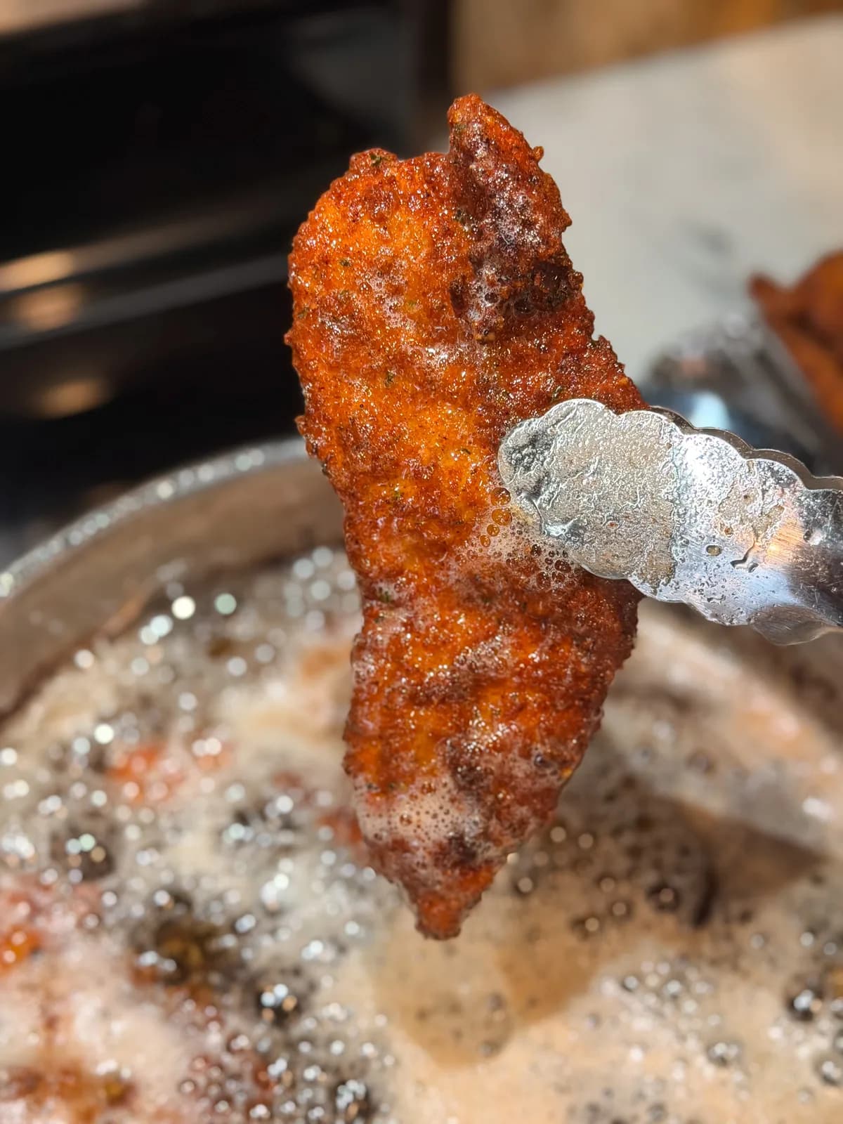 A close-up of a freshly cut breaded cutlet, juices visible