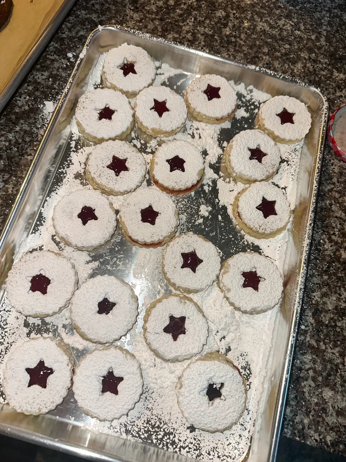 Linzer cookies with raspberry jam centers, dusted with sugar