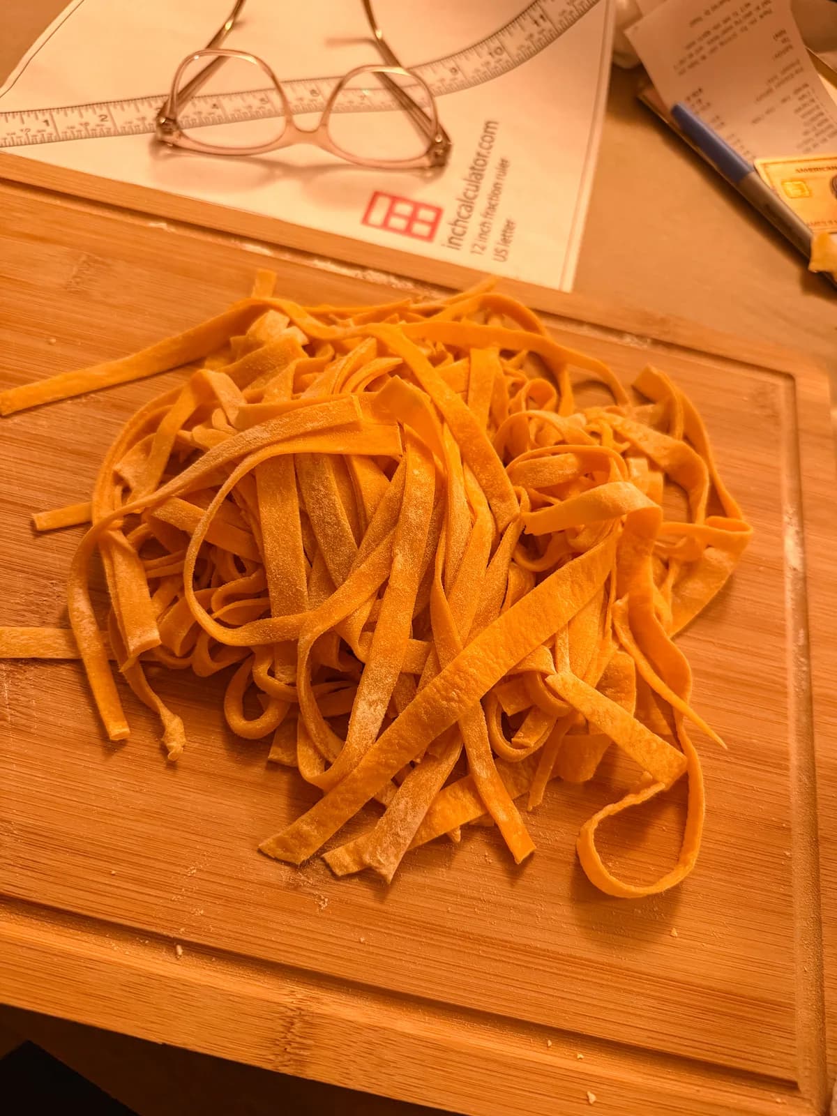 Hands shaping fresh pasta on a flour-dusted counter during a pasta class
