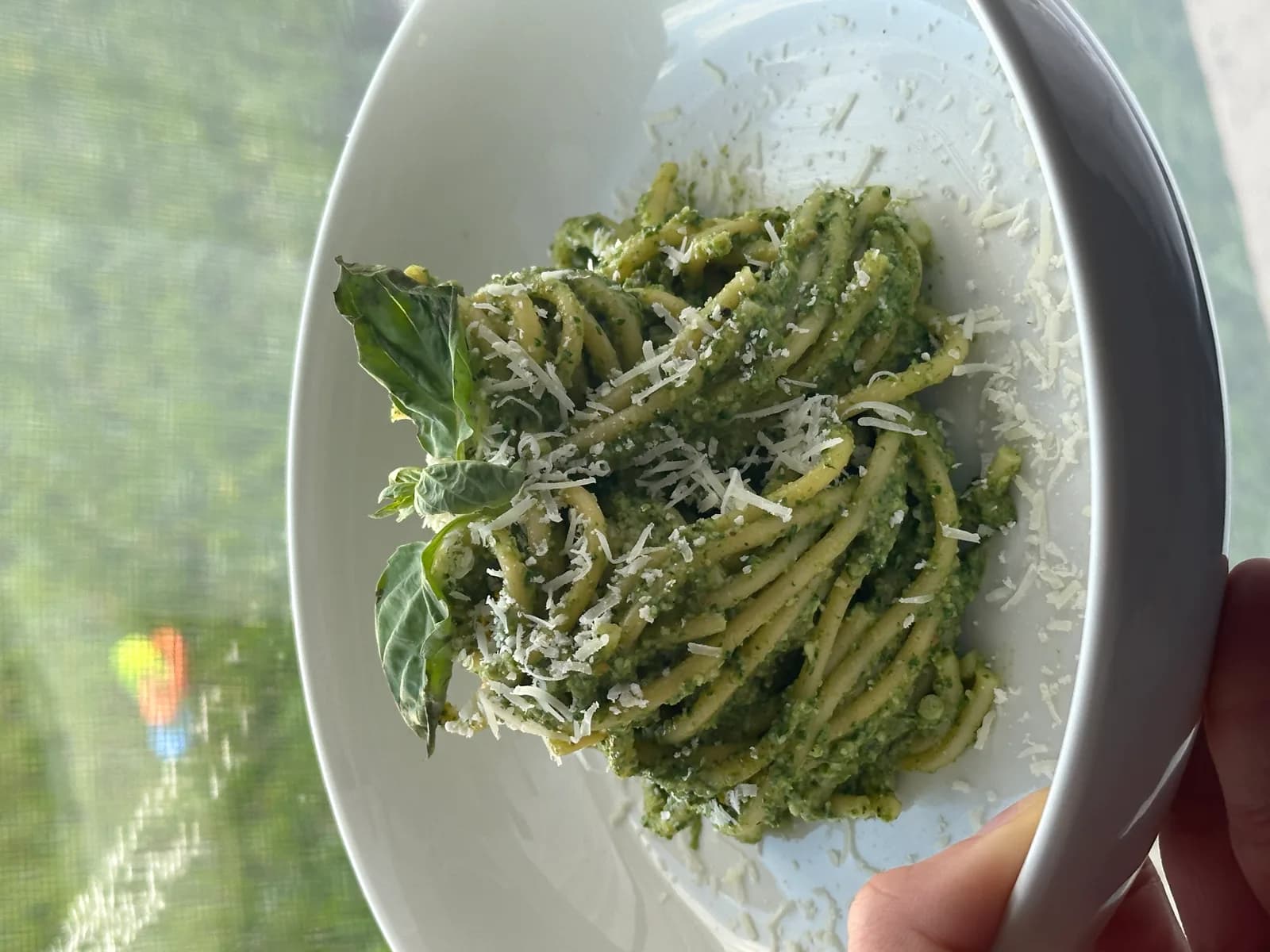 A bright green basil pesto in a small bowl