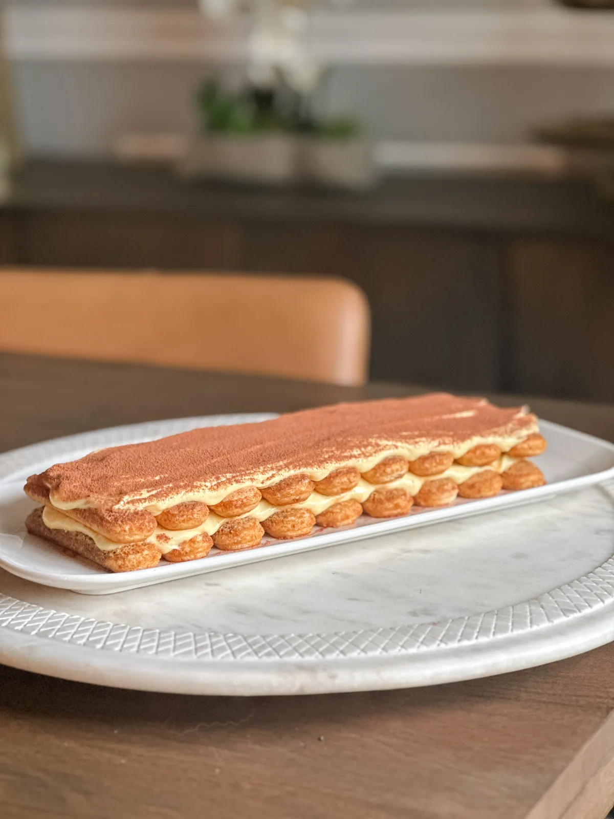 A square of tiramisu with cocoa dusted on top